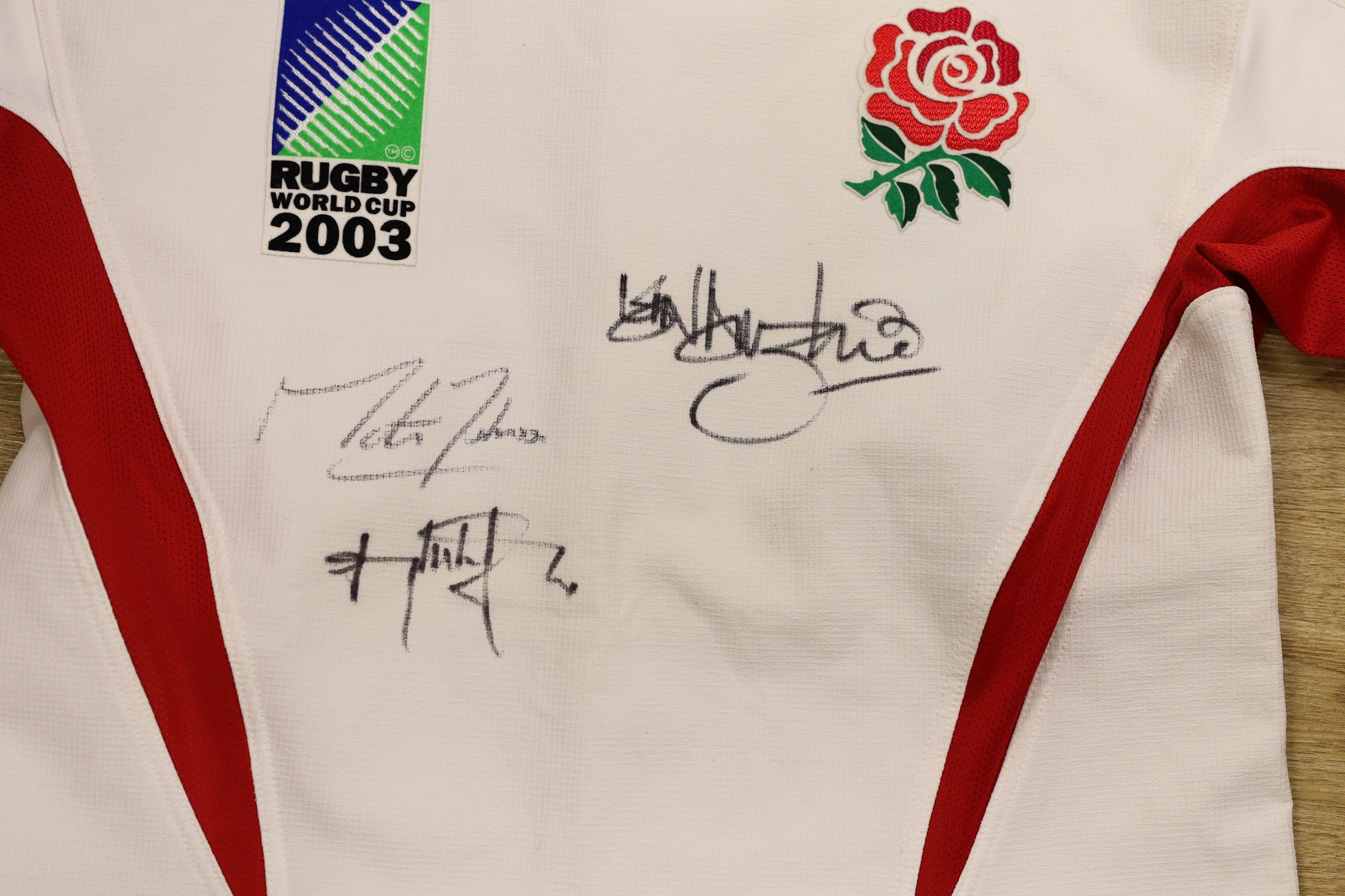 An England Rugby World Cup 2003 shirt signed by Martin Johnson, and two other players and a Hampshire county cricket club shirt signed to JJ best wishes
